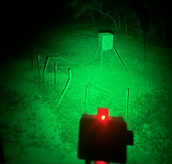 Hog feeder light illuminating hogs at night without spooking them